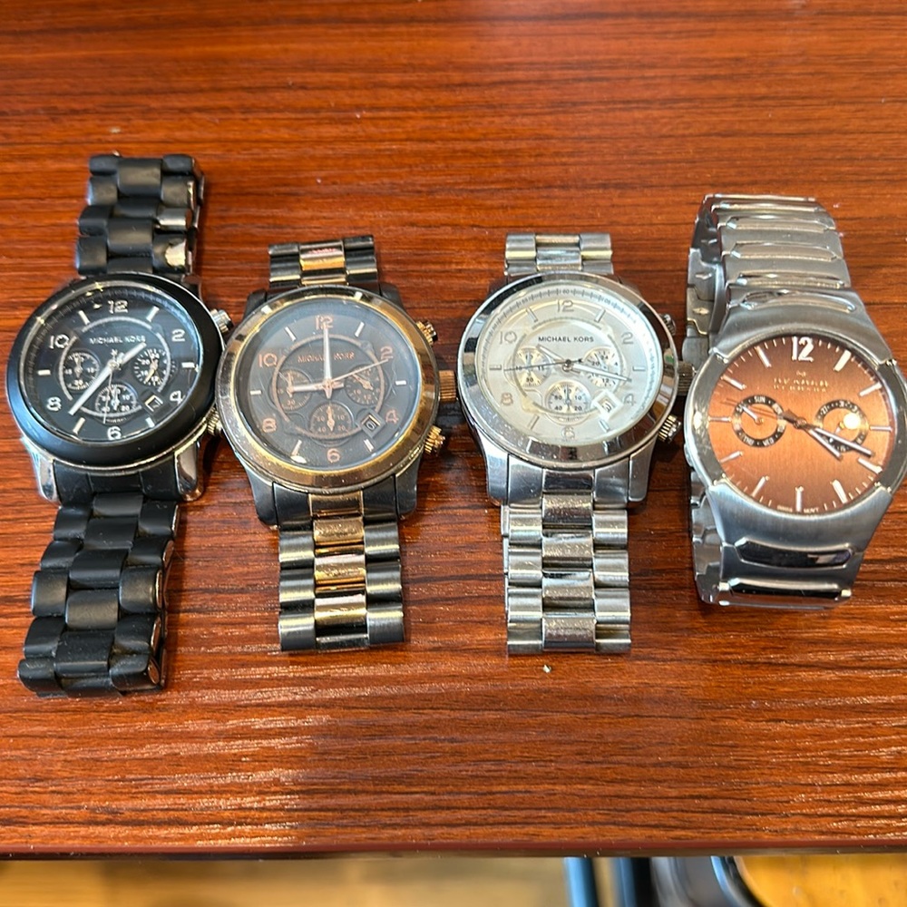 3 Michael Kors and 1 Skagen watch.